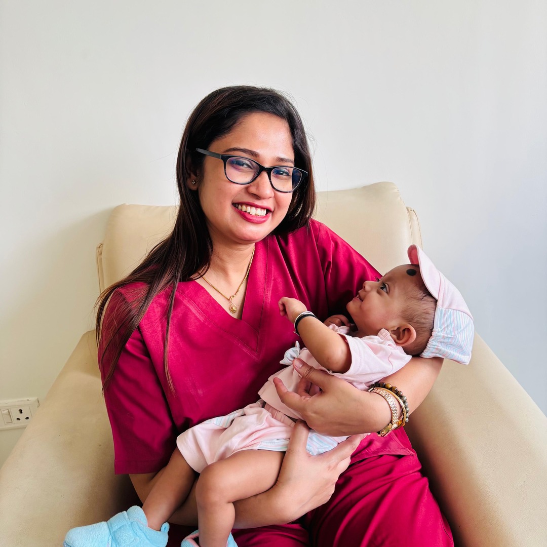 HomeIVF fertility specialist holding a HomeIVF baby in the delivery-room