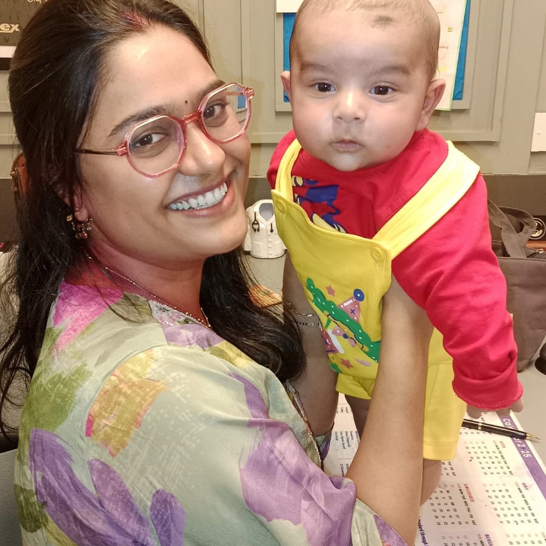 HomeIVF parents holding their newborn baby with the treating fertility doctor