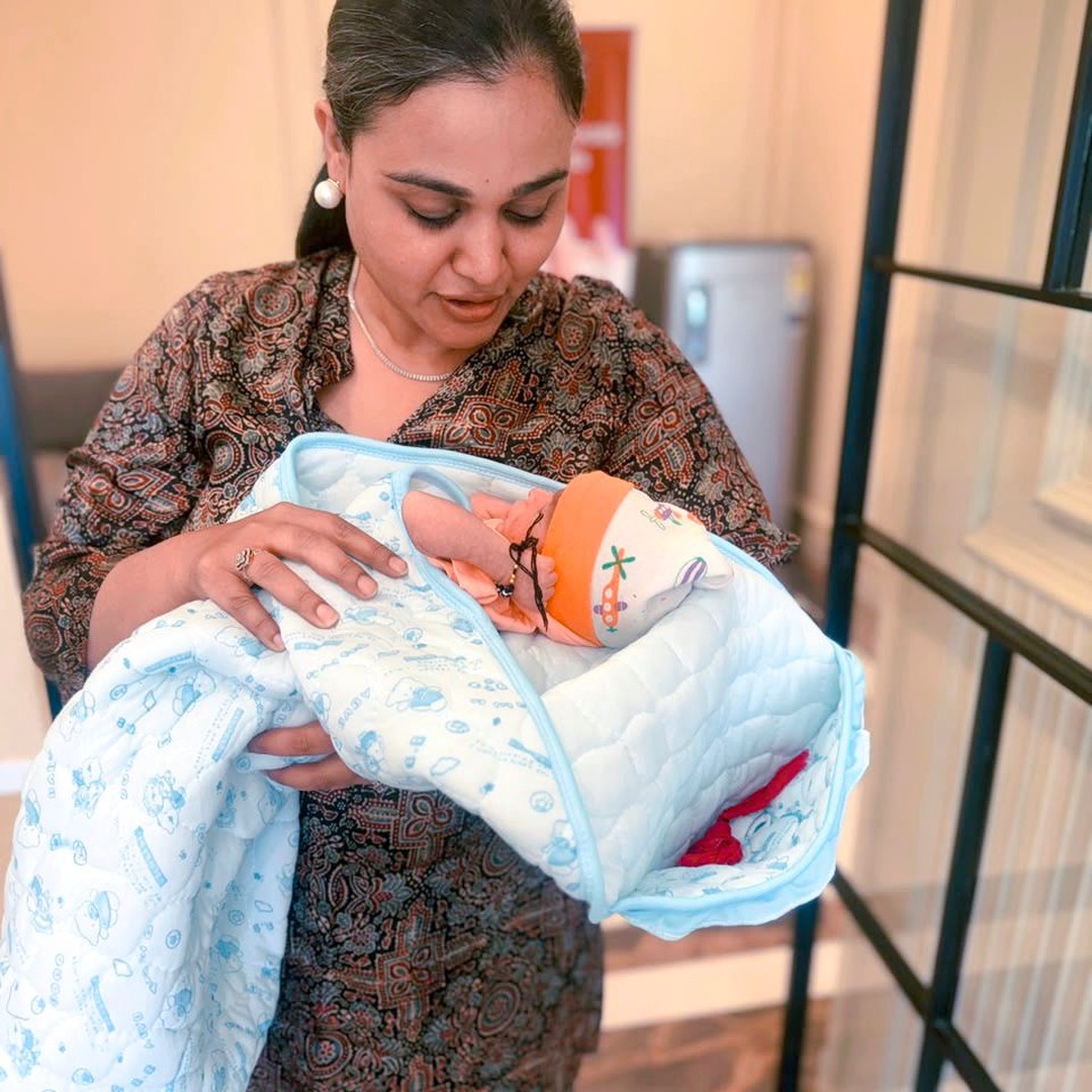 HomeIVF fertility doctors and nurses posing with a newborn IVF baby