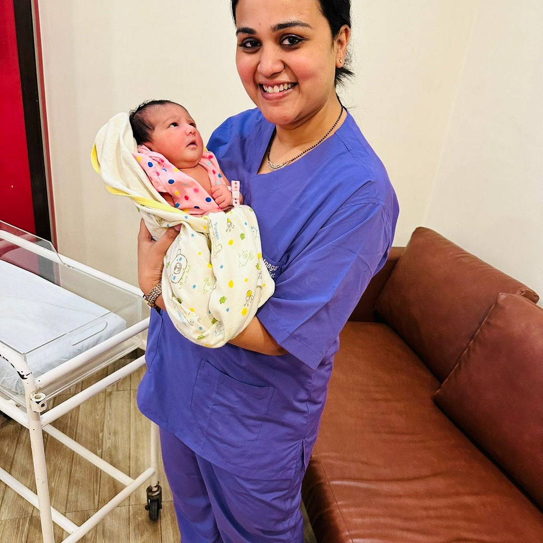 HomeIVF fertility doctor holding a HomeIVF newborn baby