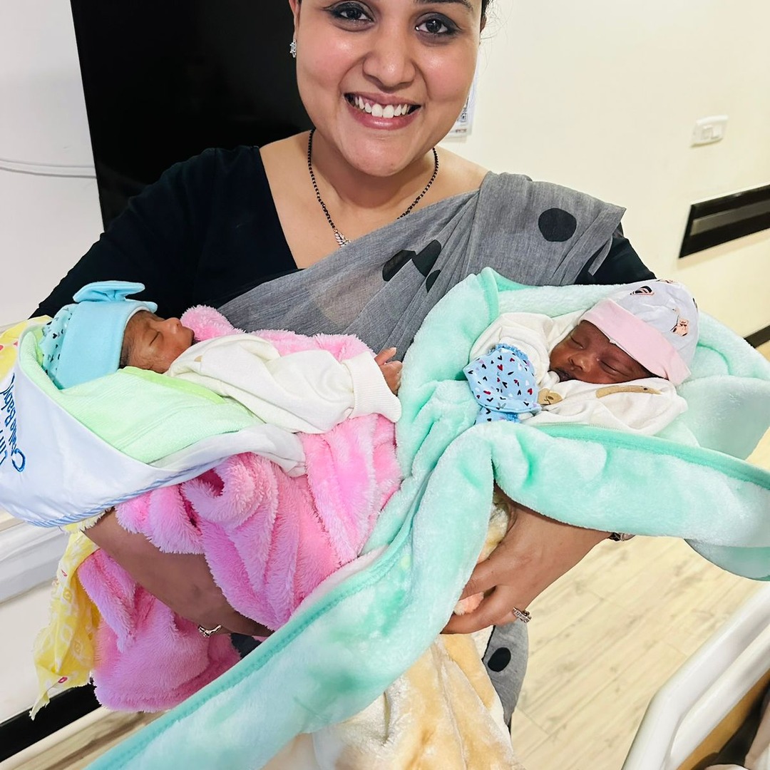 HomeIVF newborn baby held by the treating fertility specialist team