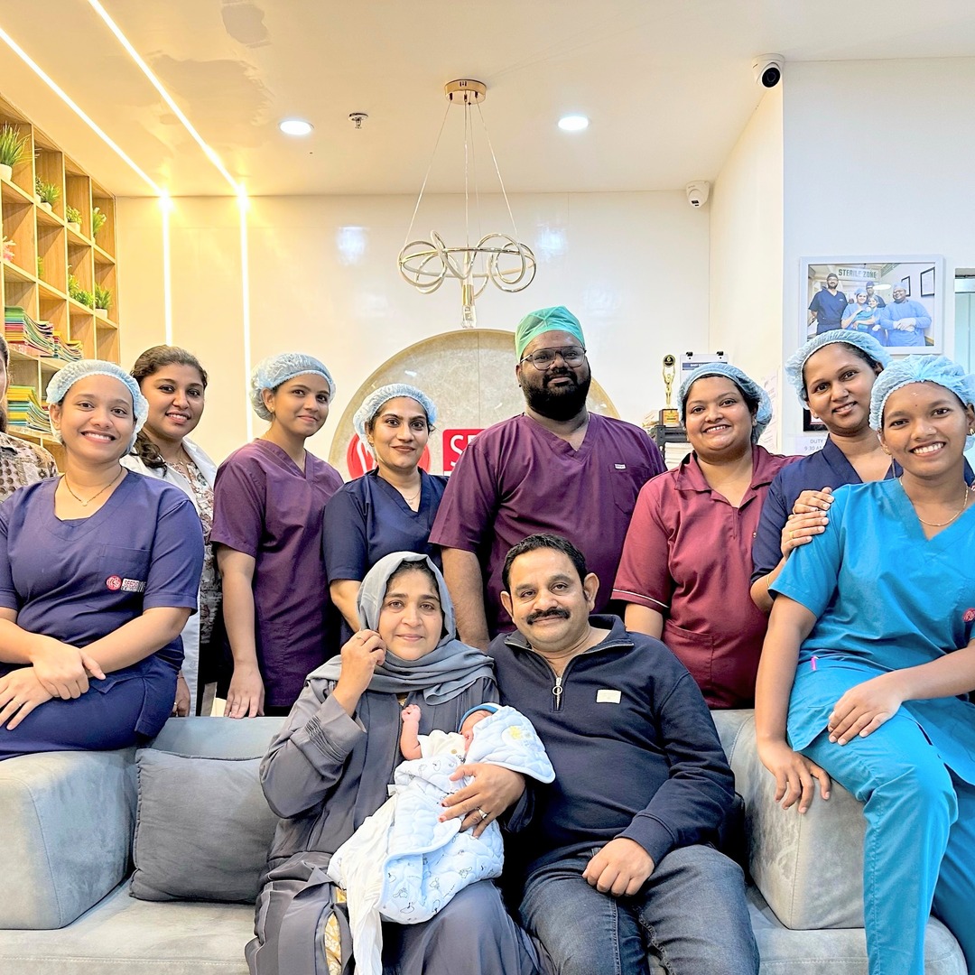 HomeIVF newborn baby with the extended family and the fertility doctor