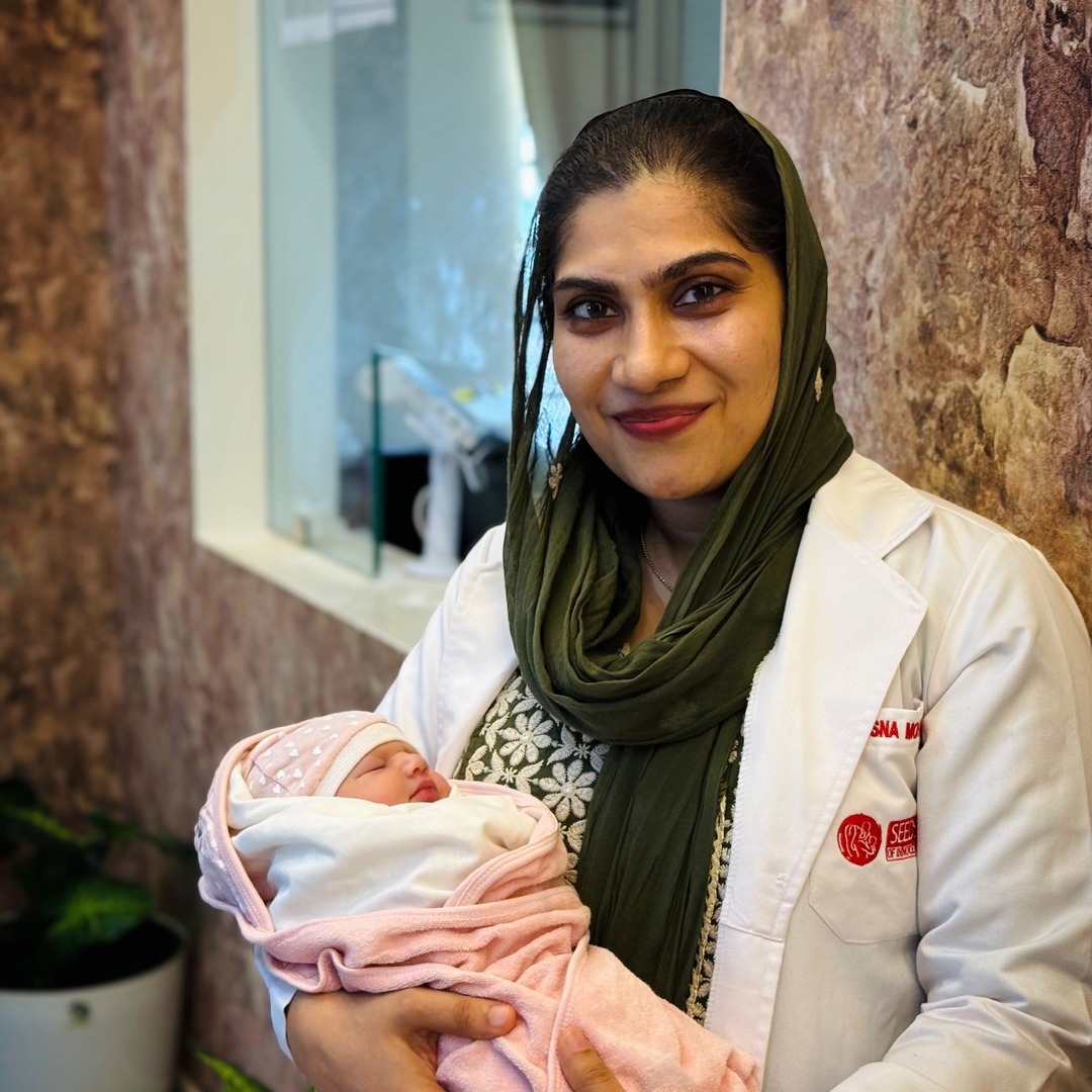 HomeIVF fertility doctor sharing a moment with a HomeIVF newborn baby